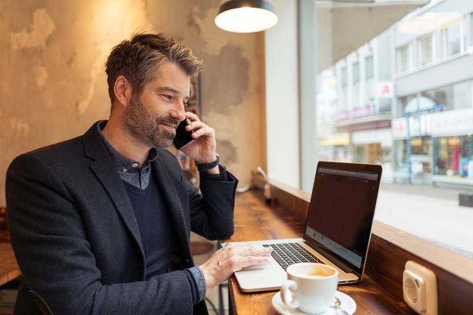 Freiberufler telefoniert im Cafe